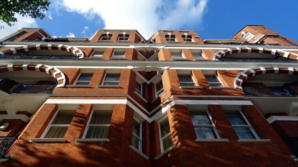 Exterior view of a pre-1960 residential block of flats, highlighting mid-century communal architecture relevant to block management.