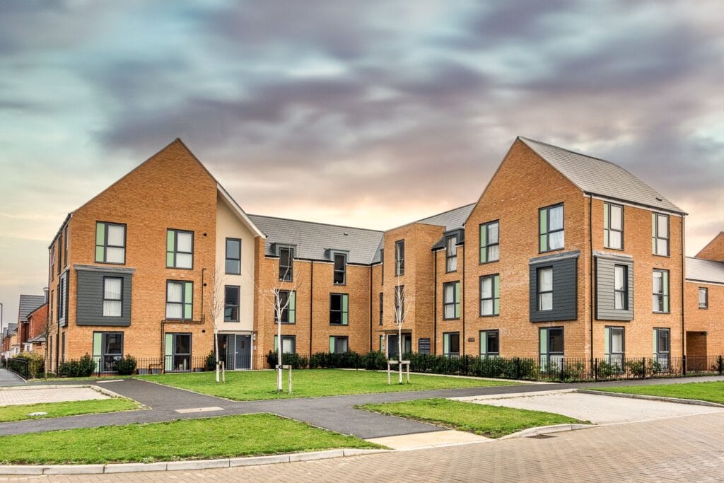 Modern flats in a newly developed residential area surrounded by landscaped greenery.