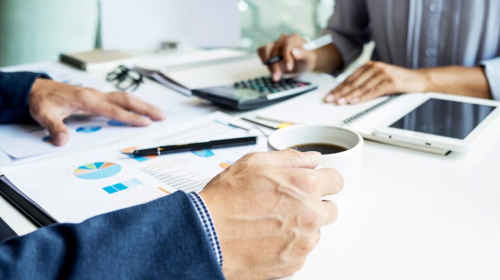 Close-up of professionals reviewing property management statistics