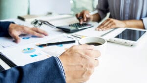 Close-up of professionals reviewing property management statistics